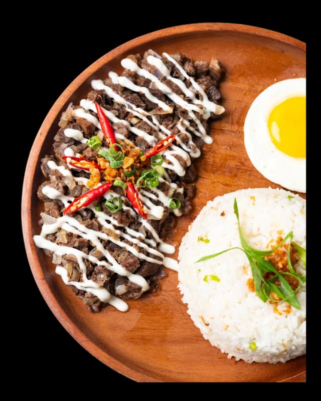 Sizzling beef sisig on a hot plate
