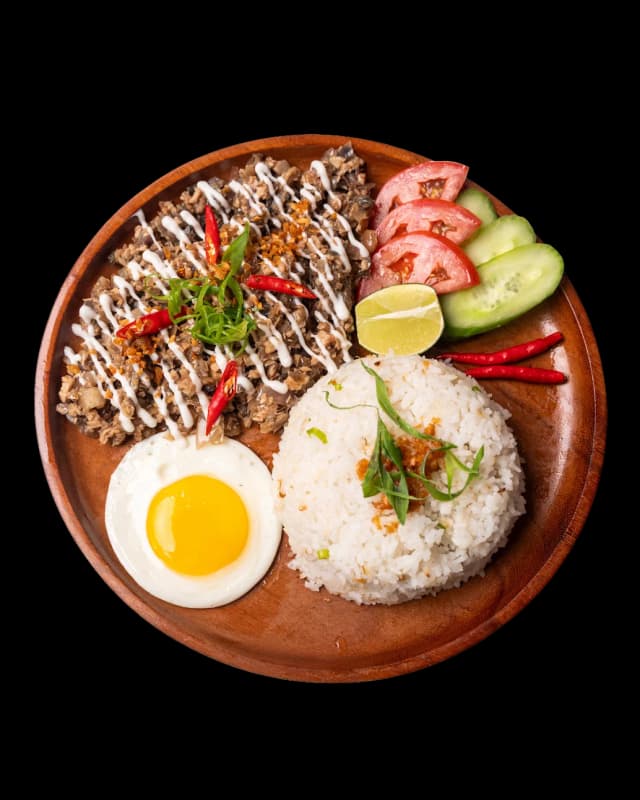 Sizzling chicken sisig on a hot plate