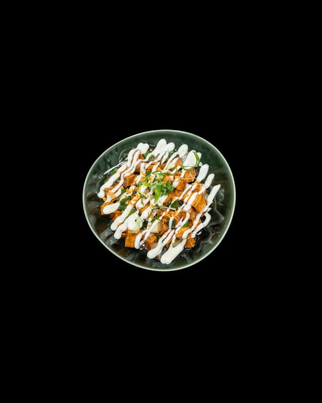 Sizzling tofu sisig on a hot plate